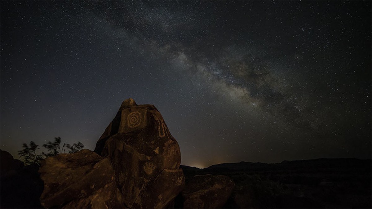 Southwest petroglyphs under night sky